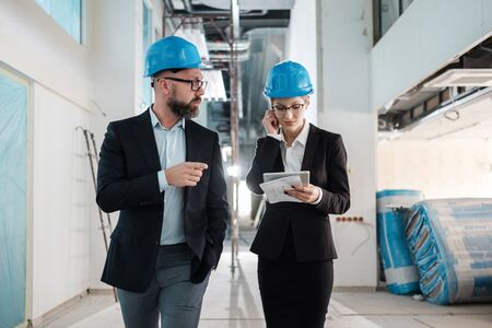 Engineers in hardhats have conversationの写真素材