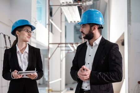 Engineers in hardhats have conversationの写真素材