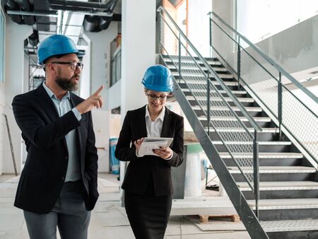 Engineers in hardhats have conversation