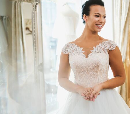 Beautifu bride choosing wedding dress in a wedding salonの写真素材