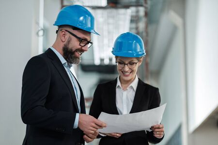 Engineers in hardhats have conversationの写真素材