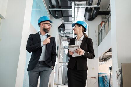 Engineers in hardhats have conversationの写真素材
