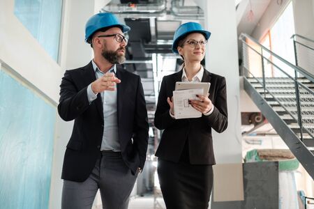 Engineers in hardhats have conversationの写真素材