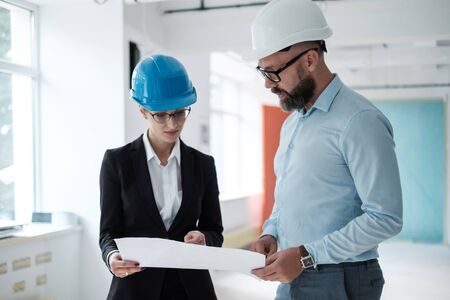 Engineers in hardhats have conversation