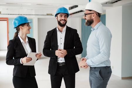 Engineers in hardhats have conversation