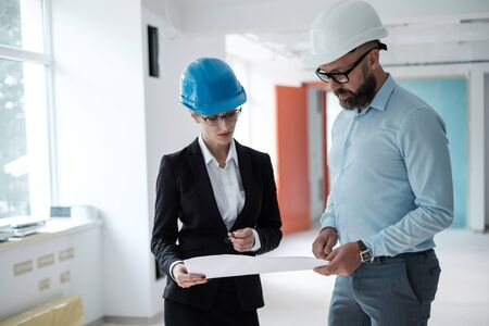 Engineers in hardhats have conversationの写真素材