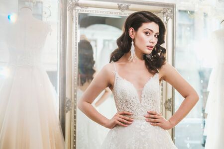 Beautifu bride choosing wedding dress in a wedding salonの写真素材