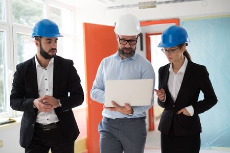 Engineers in hardhats have conversationの写真素材