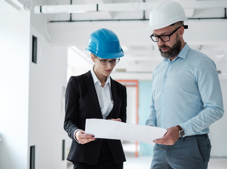Engineers in hardhats have conversationの写真素材