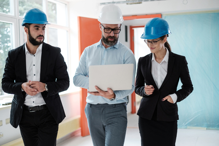 Engineers in hardhats have conversationの写真素材