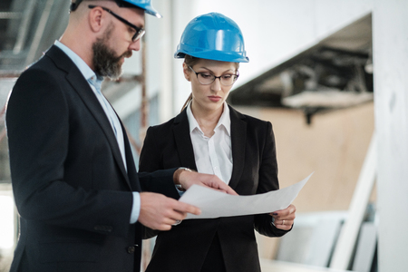 Engineers in hardhats have conversationの写真素材