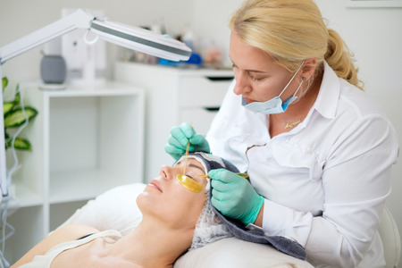 Procedure of eyelash extension in salon by cosmeticianの写真素材