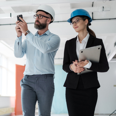 Engineers in hardhats inspecting building