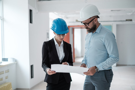Engineers in hardhats have conversationの写真素材
