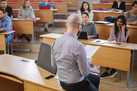 Lecturer and multinational group of students in an auditoriumの写真素材