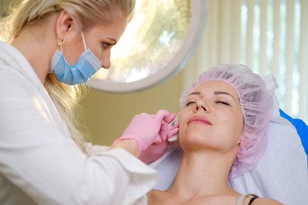 Woman getting treatment with injectable hyaluronic acid dermal fillerの写真素材