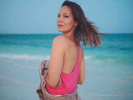 Beautiful woman relaxing near the oceanの写真素材