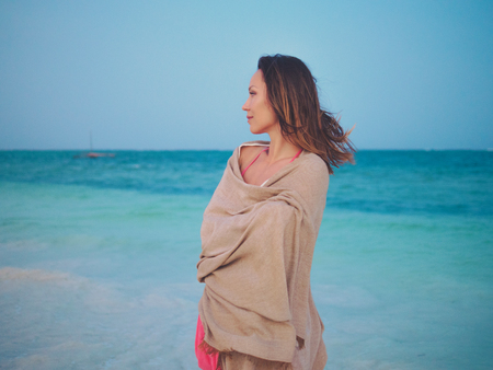 Beautiful woman relaxing near the oceanの写真素材