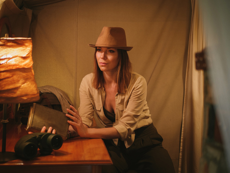 Beautiful woman in a tent at savanna, Kenyaの写真素材
