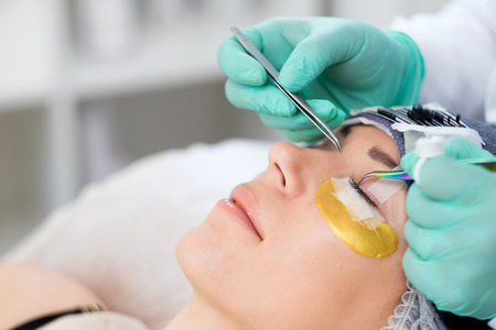 Procedure of eyelash extension in salon by cosmeticianの写真素材