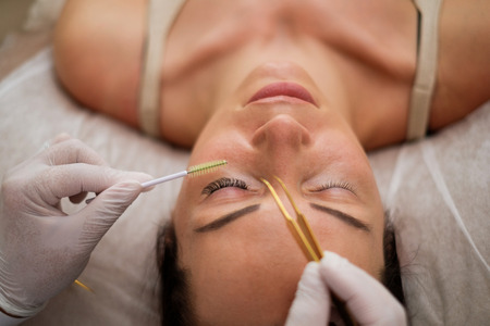 Procedure of eyelash extension in salon by cosmeticianの写真素材