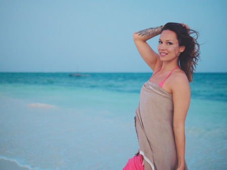 Beautiful woman relaxing near the oceanの写真素材