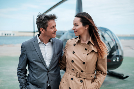 Young business couple near private helicopterの写真素材