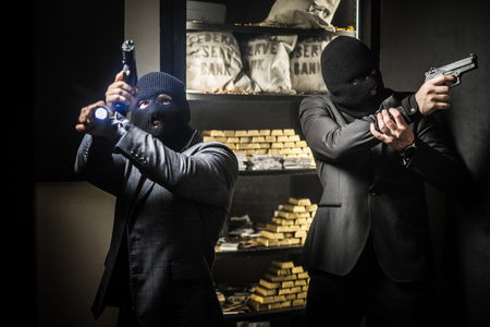 Two ardmed men robbing a bank