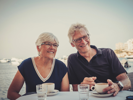 Retired couple enjoying coffee on a resort