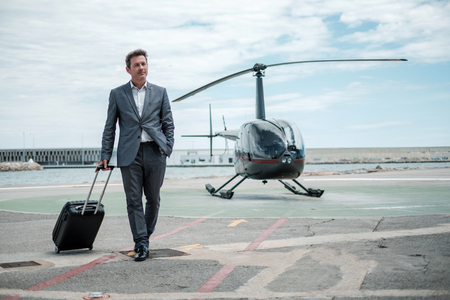 Businessman standing near private helicopterの写真素材