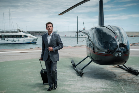 Businessman standing near private helicopterの写真素材