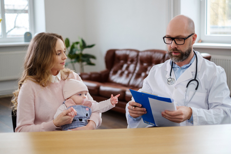 Mother with baby visiting pediatricianの写真素材