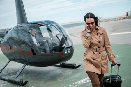 Business woman near private a helicopterの写真素材