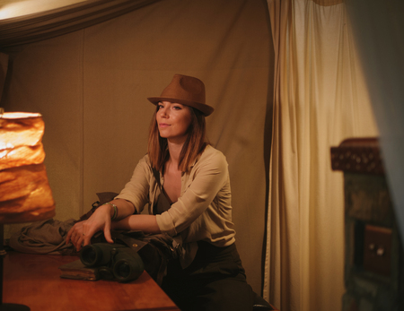 Beautiful woman in a tent at savanna, Kenyaの写真素材
