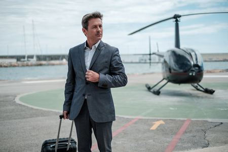 Businessman standing near private helicopterの写真素材