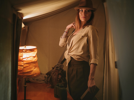 Beautiful woman in a tent at savanna, Kenyaの写真素材