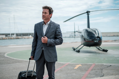 Businessman standing near private helicopterの写真素材