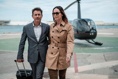 Young business couple near private helicopterの写真素材