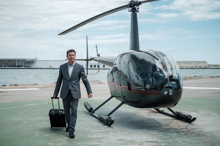 Businessman standing near private helicopterの写真素材