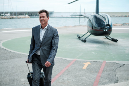 Businessman standing near private helicopterの写真素材