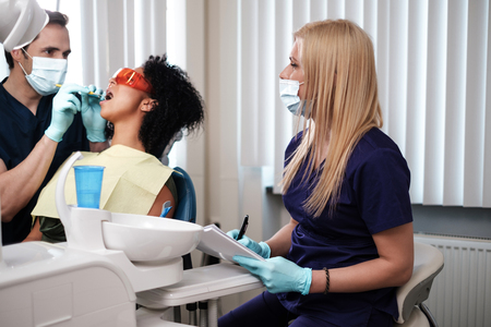 Dentist and his assitant working in private practiceの写真素材