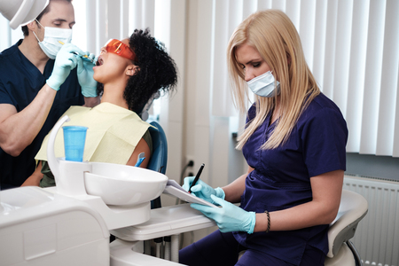 Dentist and his assitant working in private practiceの写真素材