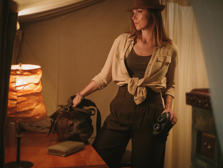 Beautiful woman in a tent at savanna, Kenyaの写真素材