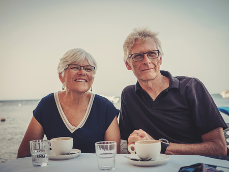 Retired couple enjoying coffee on a resortの写真素材