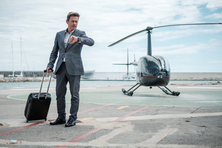 Businessman standing near private helicopterの写真素材
