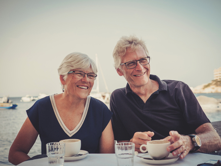 Retired couple enjoying coffee on a resortの写真素材