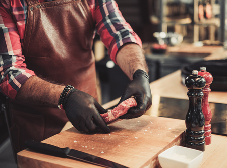 Chef preparing sterk for a grilling in a restaurantの写真素材