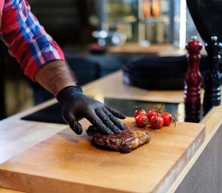 Freshly cooked beef steak on a wooden boardの写真素材