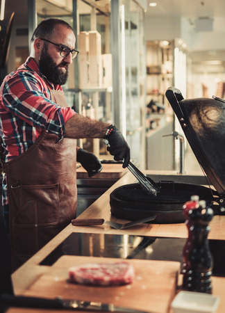 Chef preparing charcoals before grilling in a restaurantの写真素材