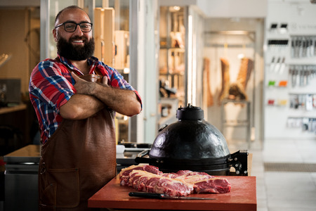 Cheefrul chef with raw beef steakes in a restaurantの写真素材